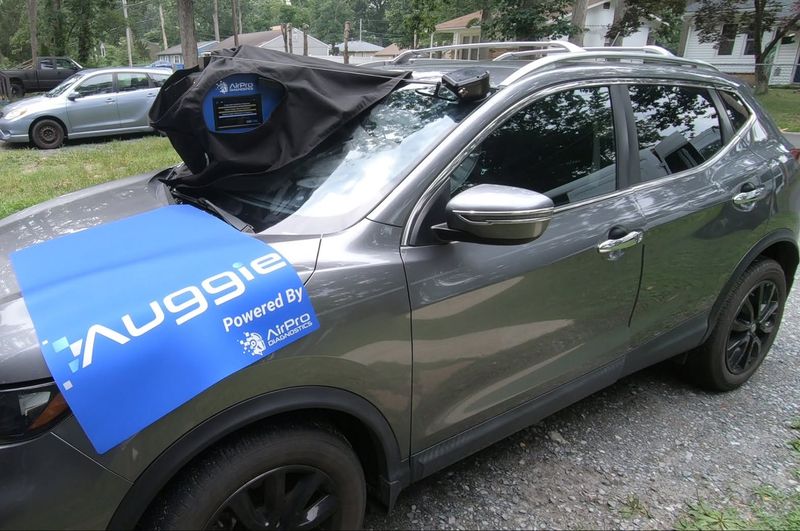 Static ADAS camera recalibration on an SUV, done right in the driveway with the Auggie unit mounted on the windshield